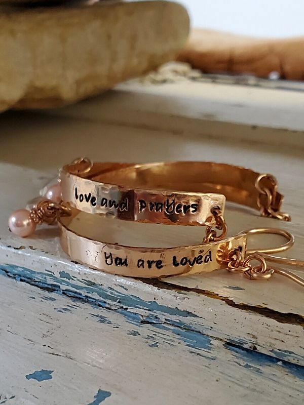 bracelets with loving words stacked on white trunk