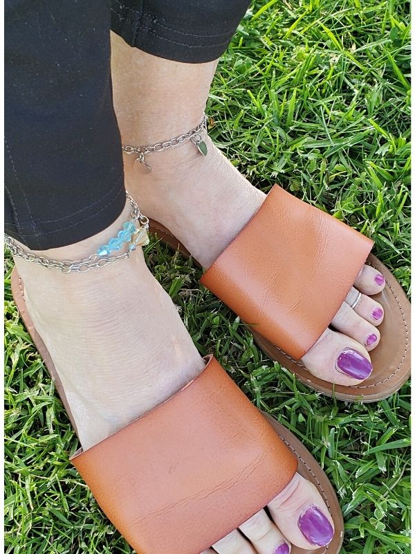 anklets on both feet with sandals