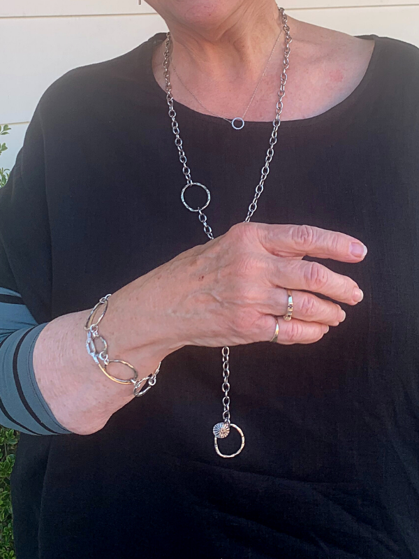 wearing black with silver jewelry