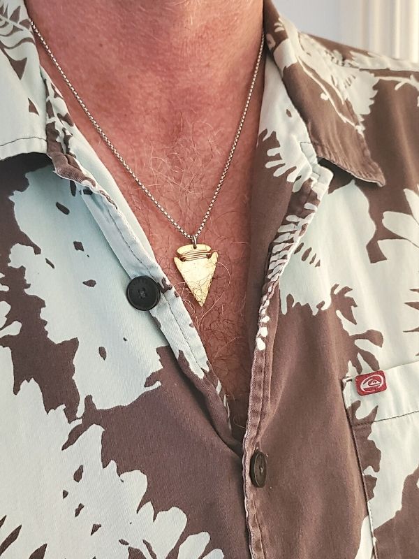 wearing arrowhead necklace with Hawaiin  print shirt