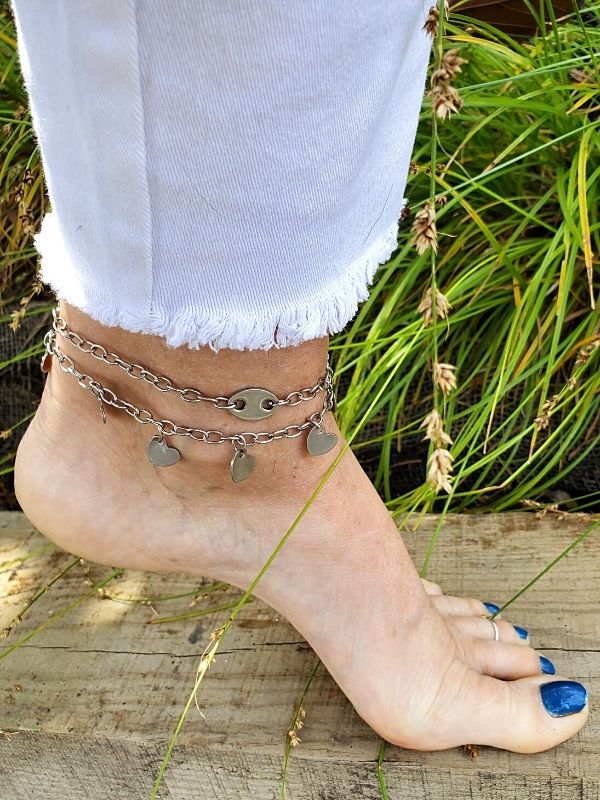 anklets on foot with white jeans