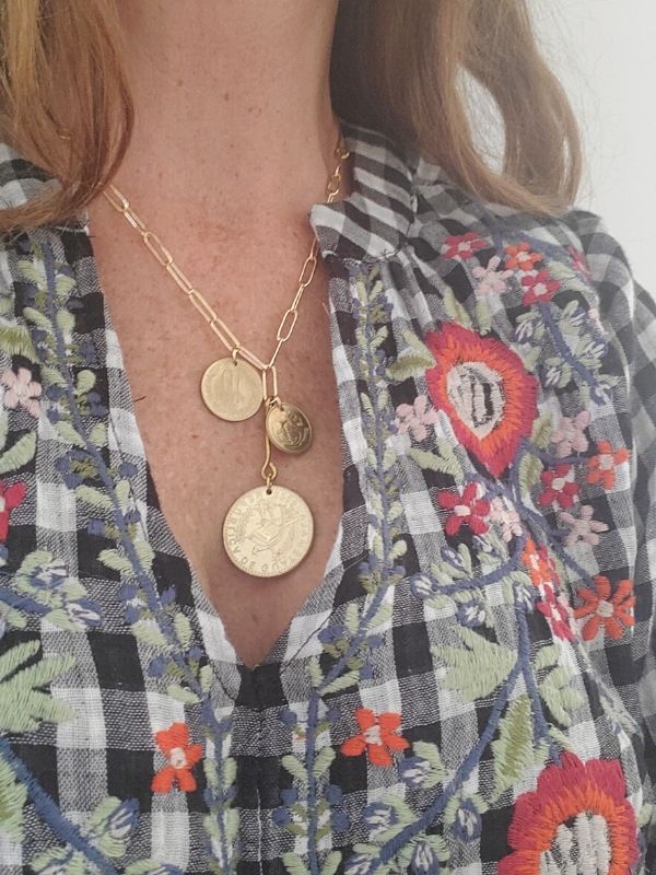 model in plaid shirt with gold coin cluster necklac
