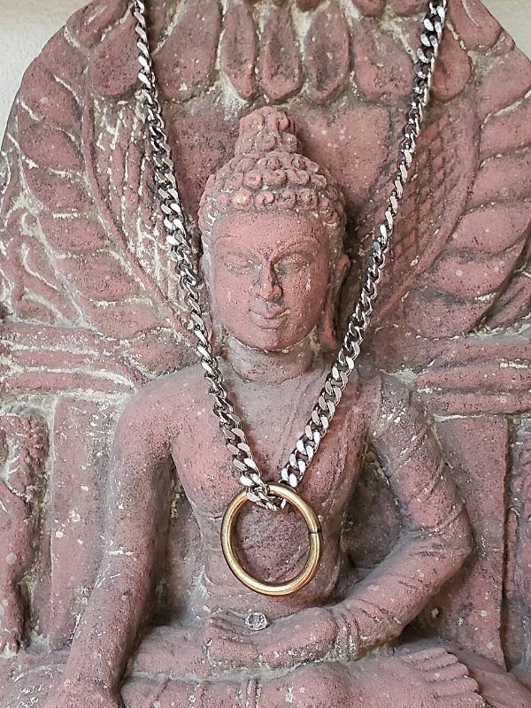 chunky necklace hanging on Budha