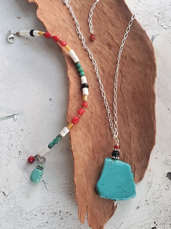 turquoise colorful gemstone necklace & bracelet on distressed table