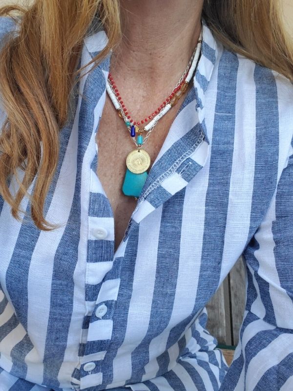 wearing layered necklaces with striped top