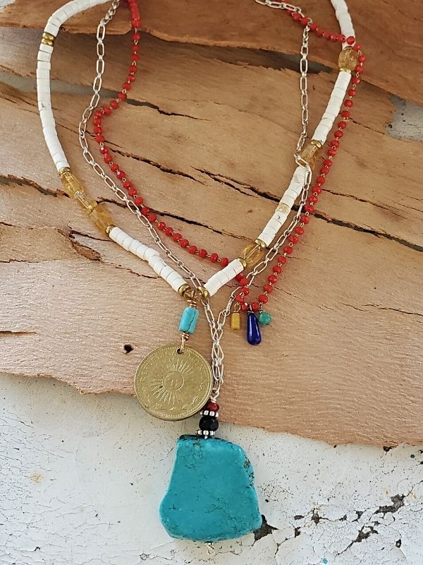3 layered gemstone necklaces on wood