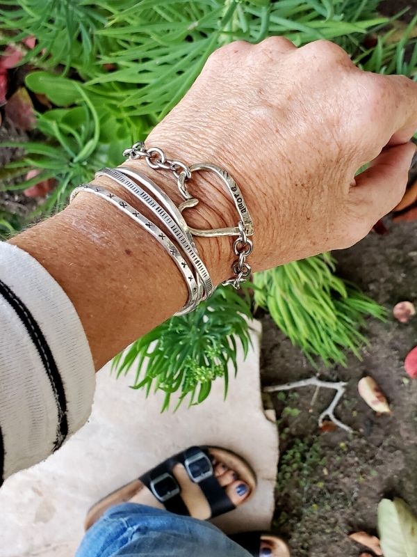 wearing silver bracelet stack with blue jeans
