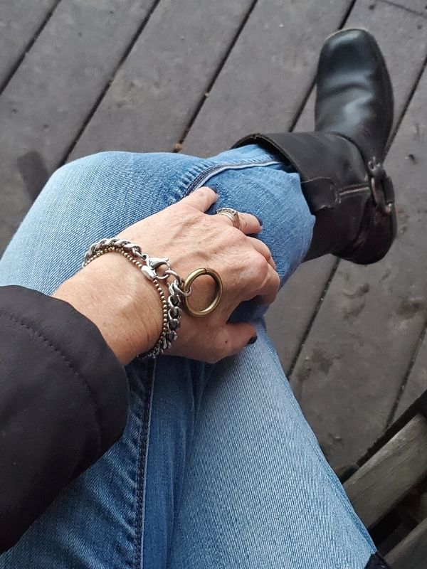 wearing boots jeans & big bracelet
