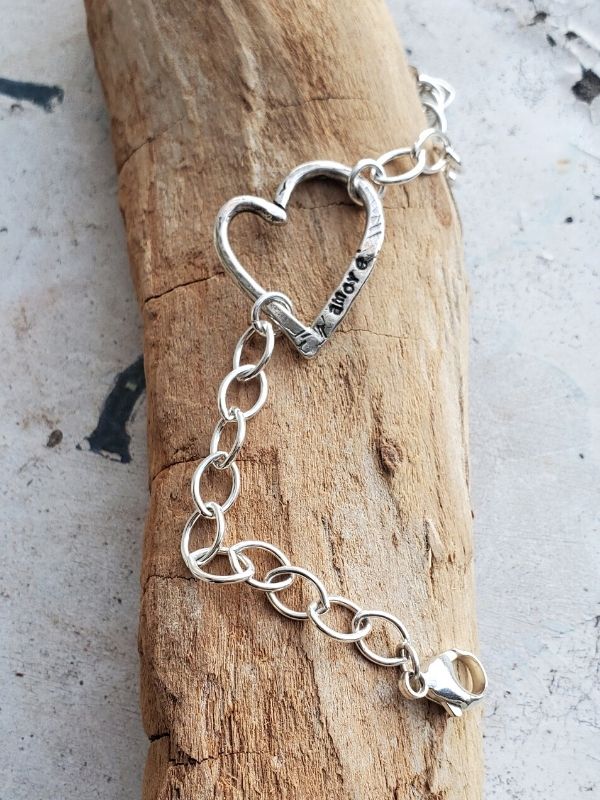 sterling silver heart bracelet on wood