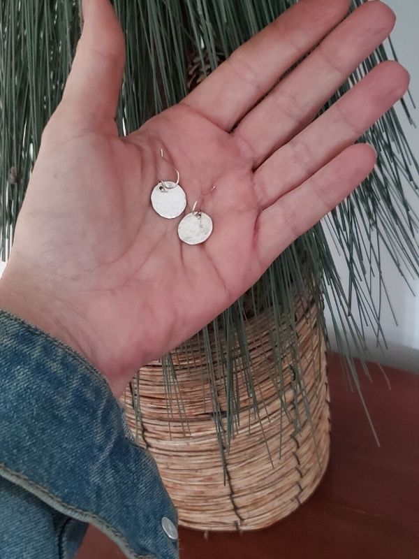 silver disc earrings in hand