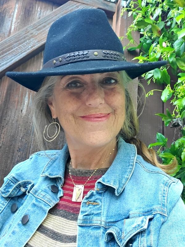 wearing spiral earrings and artsy heart necklace