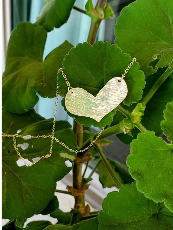 textured gold heart necklace with plants