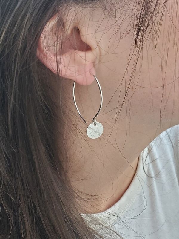 silver hoop earrings on female