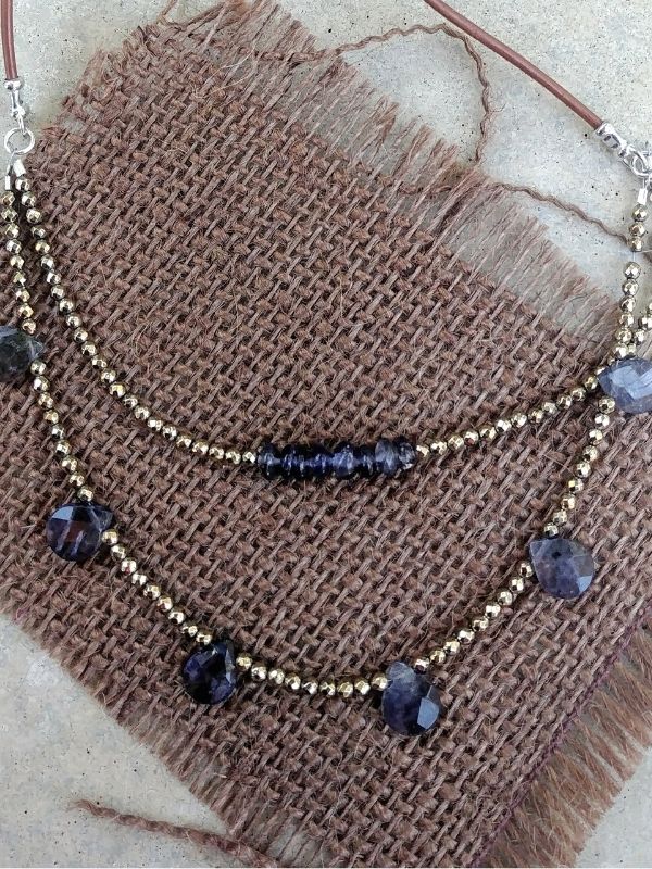 blue-violet gemstone necklace on burlap