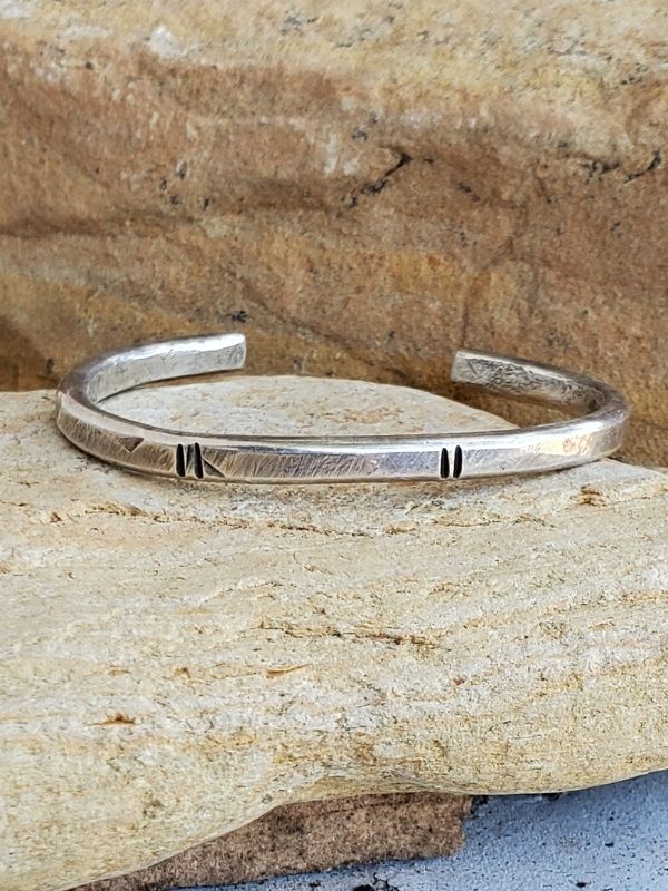 sterling silver line deign cuff on rocks