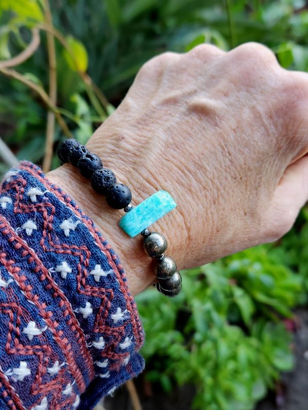 black gold green essential oil bracelet on wrist