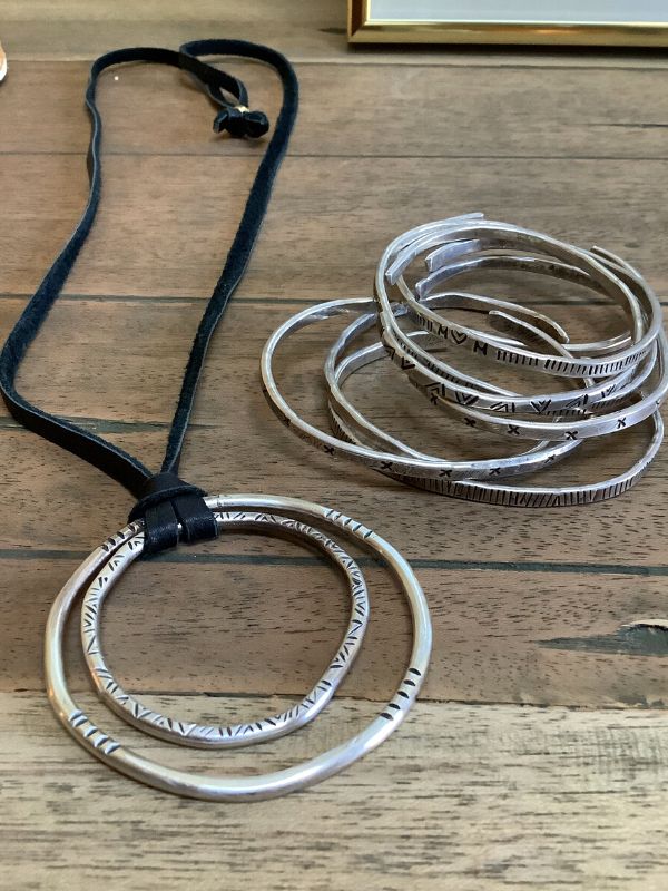 silver circle black cord necklace & silver bracelet stack displayed