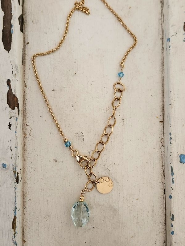 gold chain aquamarine gemstone necklace with charm displayed