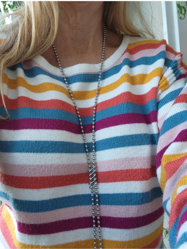 wearing colorful striped sweater long silver chain necklace