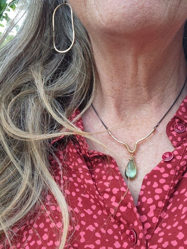 model wearing labradorite necklace gold oval earrings