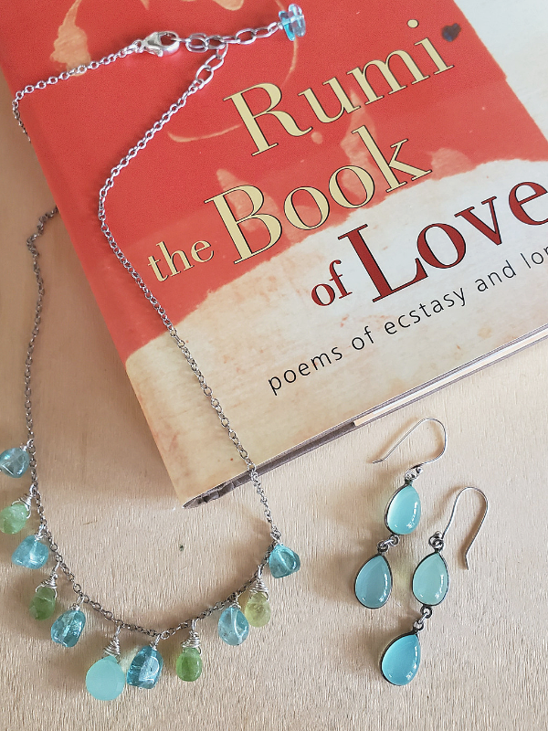 Blue green gemstone jewelry and a Rumi book on  love