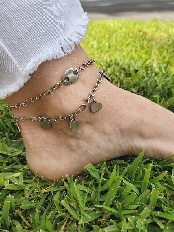 Barefoot in the grass with layered ankllets