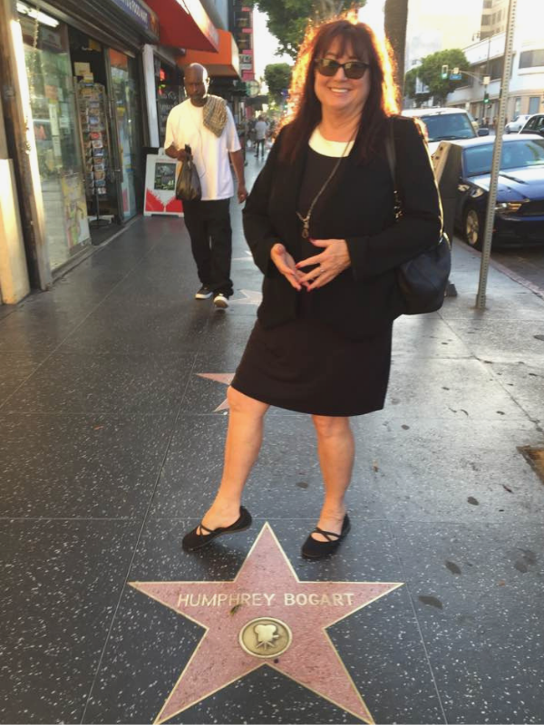 at the Hollywood walk of fame with a long necklace