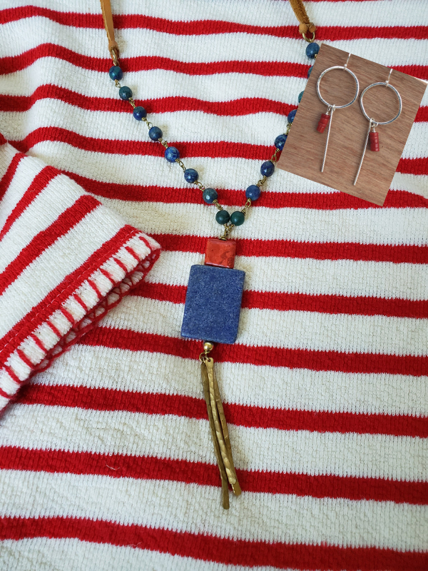 red striped top with red & blue jewelry