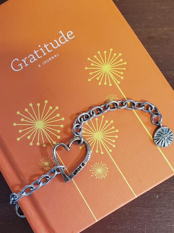 Silver chunky heart bracelet and a gratitude journal