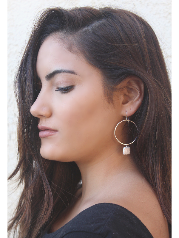 pearl hoop earrings on dark haired female profile