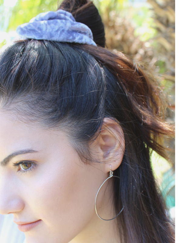 big hoop earrings on model with scarf in hair