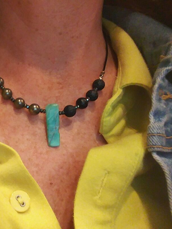 wearing yellow blouse with colorful aromatherapy gemstone necklace