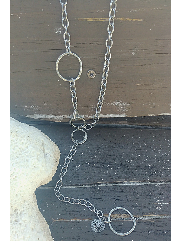 silver chunky chain necklace on wind with sand