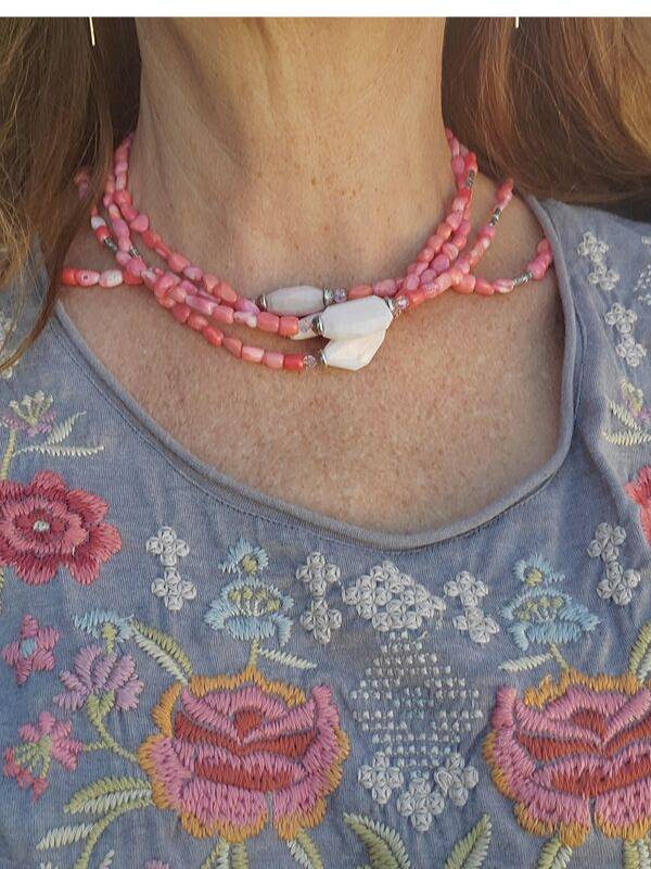 pink layered necklaces worn with a boho top