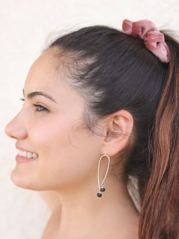high pony tail with elongated silver & black earrings