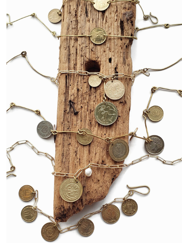 wood piece filled with coin jewelry