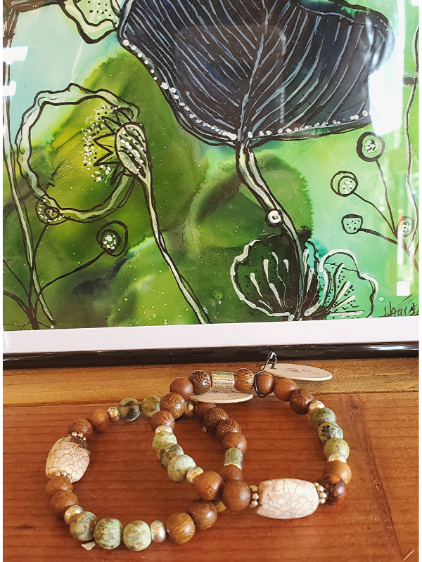 green beaded gemstone bracelets and framed art