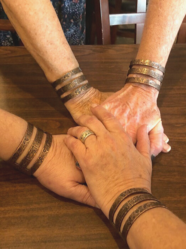 group hands wearing copper cuffs