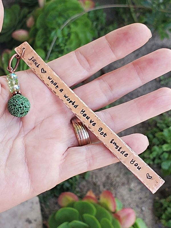 copper quote bookmark in hand