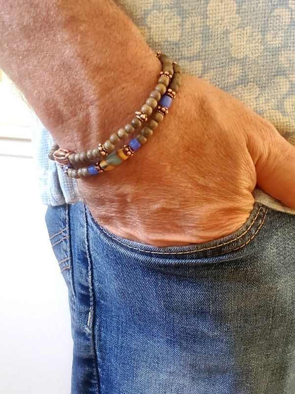 male wearing neutral beaded bracelet stack
